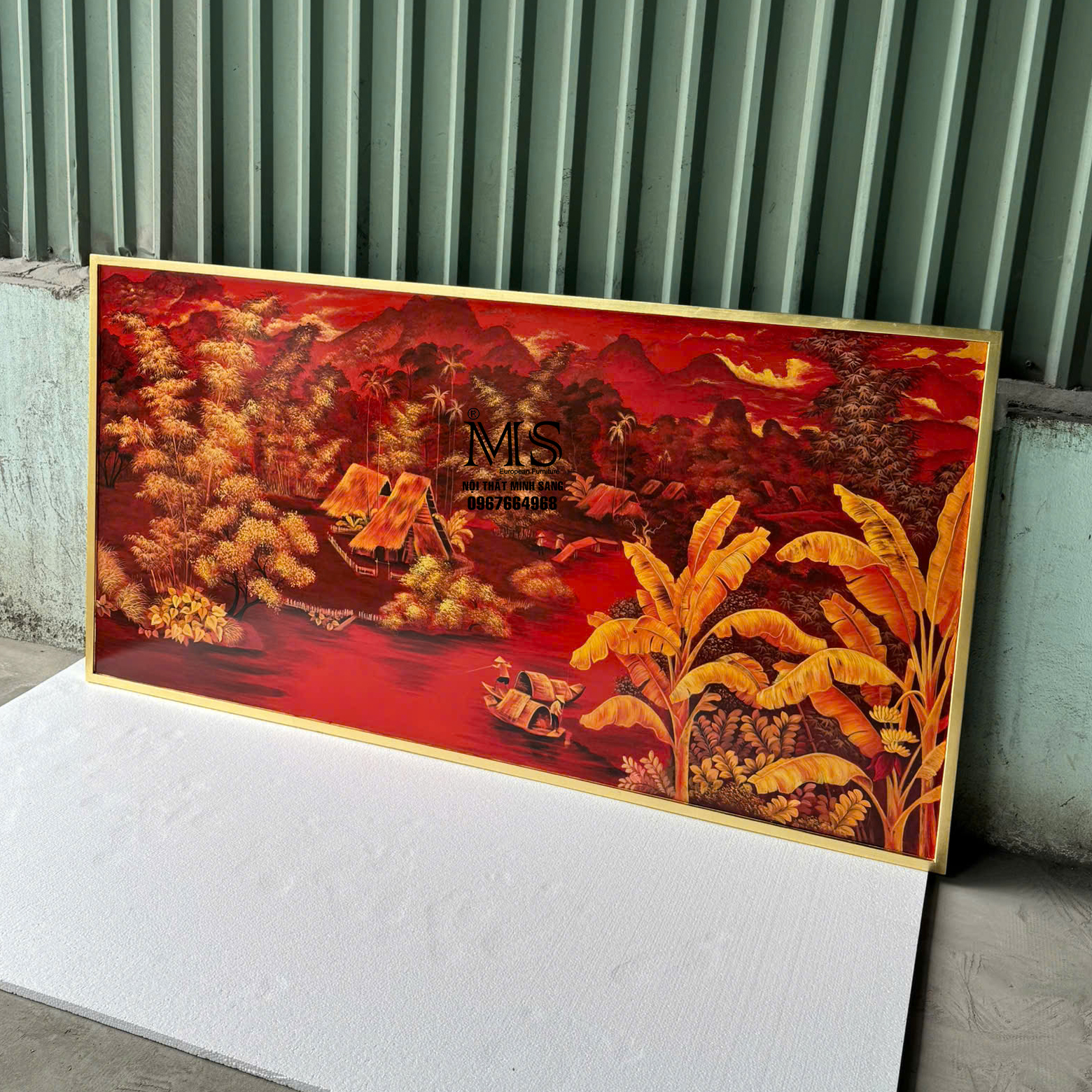 Tranh trang trí phòng khách với cảnh làng quê Việt Nam xưa, nền đỏ nổi bật